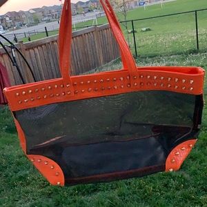 Women's Black and orange studded travel bag